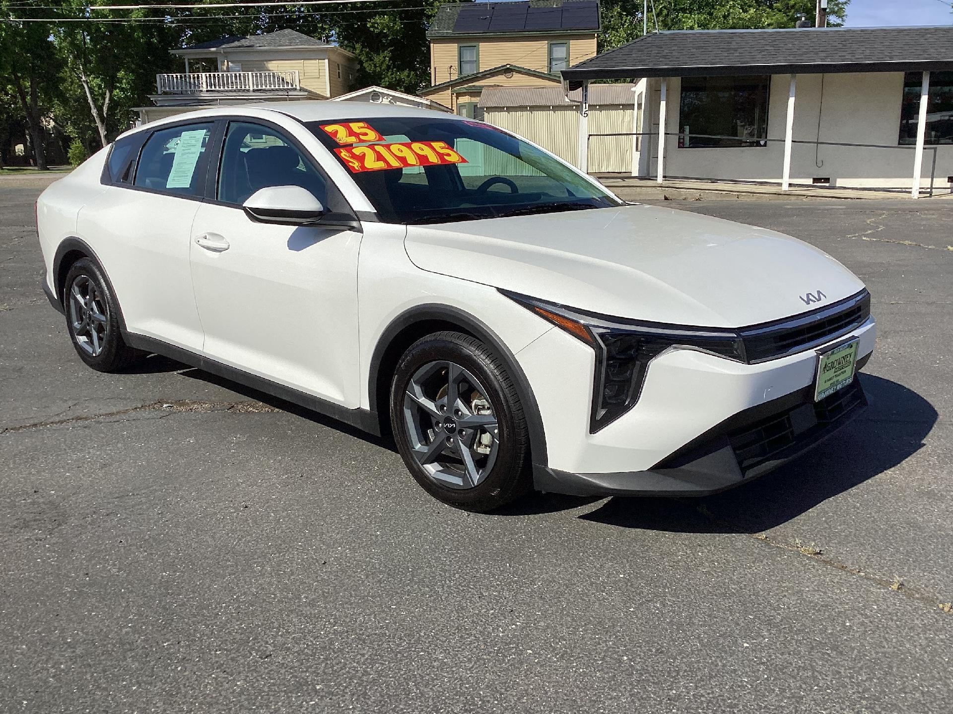 2025 Kia K4 LXS in White — front three-quarter view